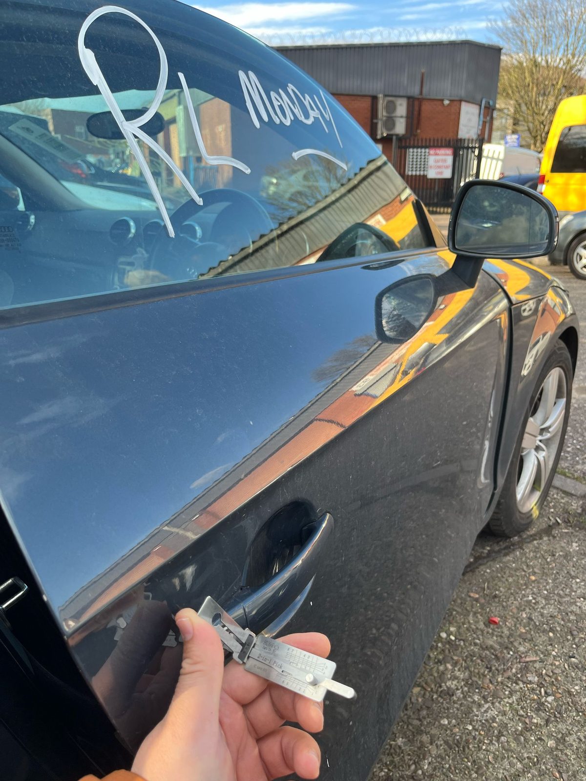 The newly produced Audi TT key held at the driver's door after programming