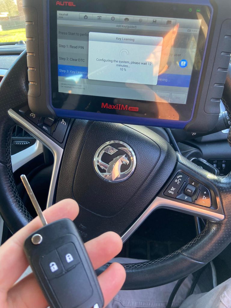 Vauxhall key programming in progress using diagnostic tool inside vehicle in Evesham
