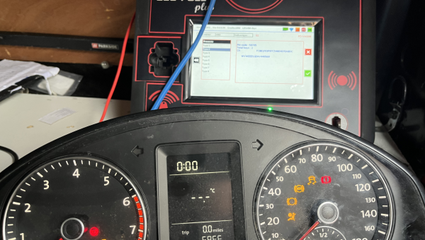 Audi A3 dashboard and new programmed smart key being held in hand